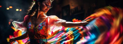 Beautiful young woman in a colorful dress dancing flamenco